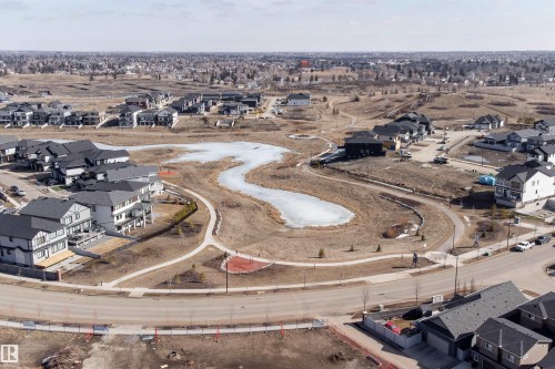 Aerial view of the community, showcasing residential properties, a winding natural body of water, and paved pathways - 6193 Carr Road, Edmonton, AB - Outdoor With View