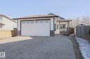 The property features a stone and siding exterior, a front entry with a covered porch, and an attached two-car garage - 205 79 Street Sw, Edmonton, AB  - Outdoor 