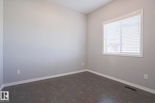 Room featuring light grey walls and dark tiled flooring - 205 79 Street Sw, Edmonton, AB - Indoor Photo Showing Other Room