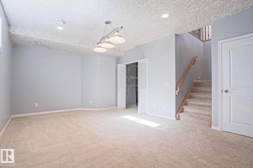 Spacious room featuring light grey walls, recessed lighting, and a light-colored carpet - 205 79 Street Sw, Edmonton, AB - Indoor Photo Showing Other Room