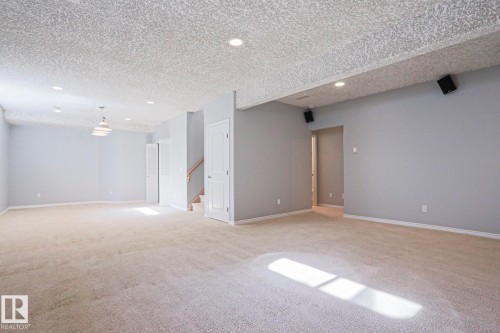 Spacious room featuring carpeting, recessed lighting, and a neutral wall color - 205 79 Street Sw, Edmonton, AB - Indoor Photo Showing Other Room