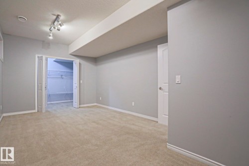 This room features light grey walls, light-colored carpet, and white trim - 205 79 Street Sw, Edmonton, AB - Indoor Photo Showing Other Room