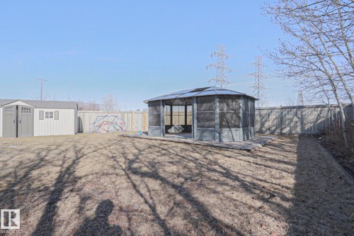 The property features an extensive yard with a lawn, a screened gazebo on a wooden deck, and a storage shed - 205 79 Street Sw, Edmonton, AB - Outdoor