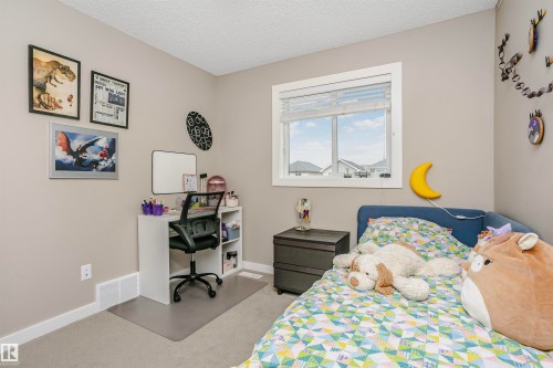 This room features neutral-toned walls, a window with blinds, and light-colored carpeting - 6116 Rosenthal Way, Edmonton, AB - Indoor Photo Showing Bedroom