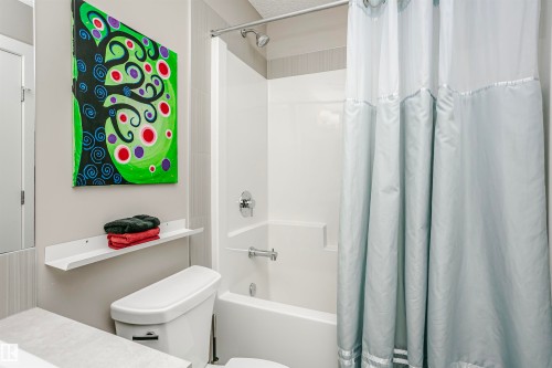 Bathroom with a white toilet, white bathtub and shower combination, and a light-colored shower curtain - 6116 Rosenthal Way, Edmonton, AB - Indoor Photo Showing Bathroom