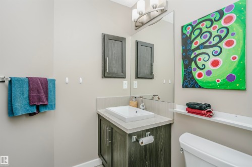 The bathroom features a modern vanity with a rectangular vessel sink and a wall-mounted mirror with overhead lighting - 6116 Rosenthal Way, Edmonton, AB - Indoor Photo Showing Bathroom