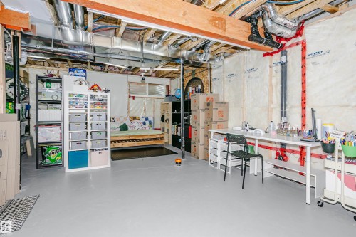 The property features an unfinished basement with exposed ceiling beams and ductwork, providing potential for customization - 6116 Rosenthal Way, Edmonton, AB - Indoor Photo Showing Basement