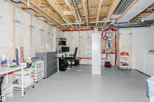 Spacious unfinished basement with exposed ceiling beams and painted concrete flooring - 6116 Rosenthal Way, Edmonton, AB - Indoor Photo Showing Basement
