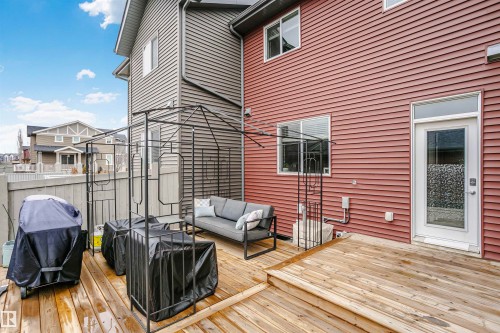 The property features a wooden deck with steps, offering outdoor space for relaxation - 6116 Rosenthal Way, Edmonton, AB - Outdoor With Deck Patio Veranda With Exterior