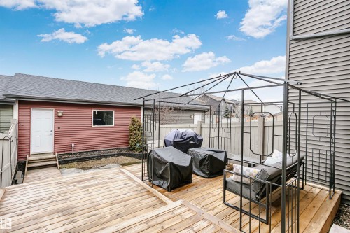 The property features a spacious wooden deck, ideal for outdoor living - 6116 Rosenthal Way, Edmonton, AB - Outdoor With Deck Patio Veranda