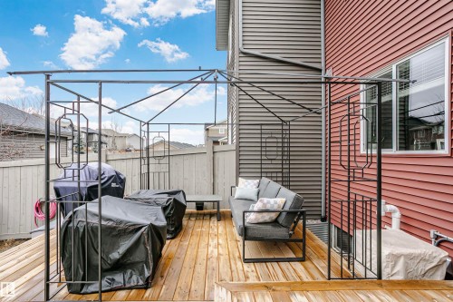 This property features an outdoor deck with wooden flooring and a metal gazebo structure, providing an inviting space for relaxation - 6116 Rosenthal Way, Edmonton, AB - Outdoor With Deck Patio Veranda