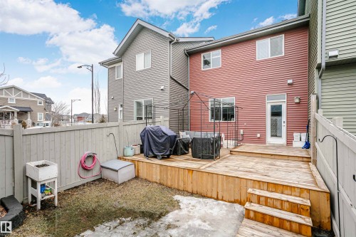 The property features a private fenced yard with a wooden deck and steps - 6116 Rosenthal Way, Edmonton, AB - Outdoor With Deck Patio Veranda With Exterior