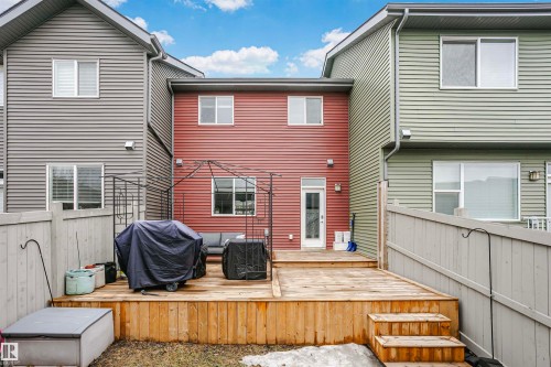 The property features an extensive wooden deck with stairs leading to the yard - 6116 Rosenthal Way, Edmonton, AB - Outdoor With Deck Patio Veranda With Exterior