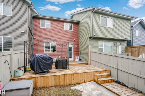 The property features an outdoor wooden deck with steps, a fenced yard, and a wooden access ramp - 6116 Rosenthal Way, Edmonton, AB - Outdoor With Deck Patio Veranda With Exterior