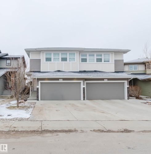 The property features a two-story exterior with light-colored siding and a dark roof - 2878 Koshal Crescent, Edmonton, AB - Outdoor With Facade