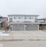 The property features a two-story exterior with light-colored siding and a dark roof - 2878 Koshal Crescent, Edmonton, AB  - Outdoor With Facade 