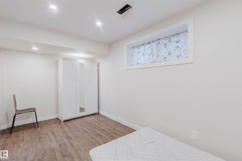 This room features light-colored walls, recessed lighting, and wood-look flooring - 2878 Koshal Crescent, Edmonton, AB - Indoor