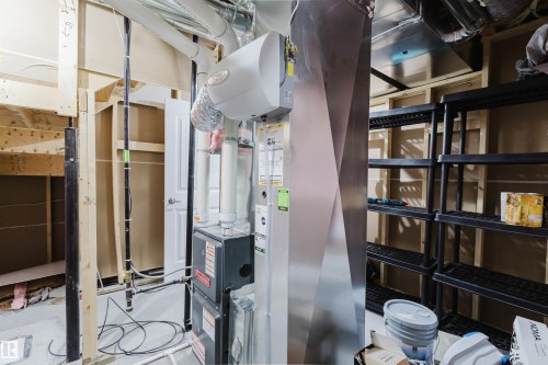 The property features exposed wooden framing, white PVC pipes, and a furnace system - 2878 Koshal Crescent, Edmonton, AB - Indoor