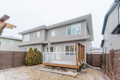 The property features a two-story exterior with light gray siding and white trim - 2878 Koshal Crescent, Edmonton, AB - Outdoor With Deck Patio Veranda