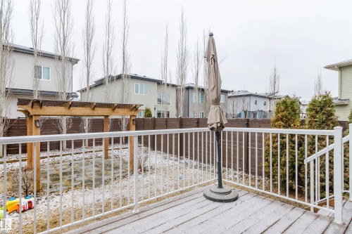 The property includes a wooden deck with white railings, a wooden pergola, and a private fenced yard - 2878 Koshal Crescent, Edmonton, AB - Outdoor With Deck Patio Veranda