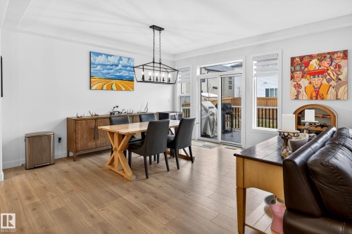 This open-concept dining area features light wood flooring and white walls - 345 Meadowview Drive, Fort Saskatchewan, AB - Indoor