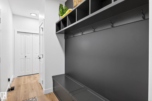 Mudroom featuring a built-in storage unit with hooks and cubbies, a bench, and light-toned flooring - 345 Meadowview Drive, Fort Saskatchewan, AB - Indoor