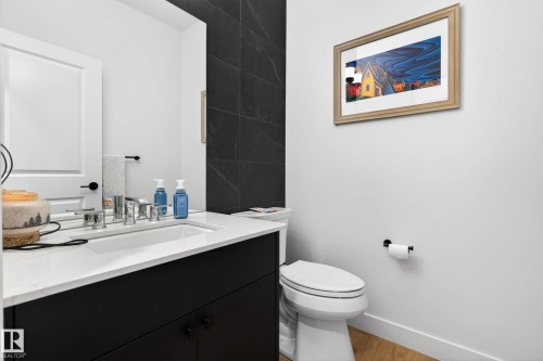 Bathroom featuring a vanity with a white countertop and a rectangular sink, chrome hardware, and a toilet - 345 Meadowview Drive, Fort Saskatchewan, AB - Indoor Photo Showing Bathroom