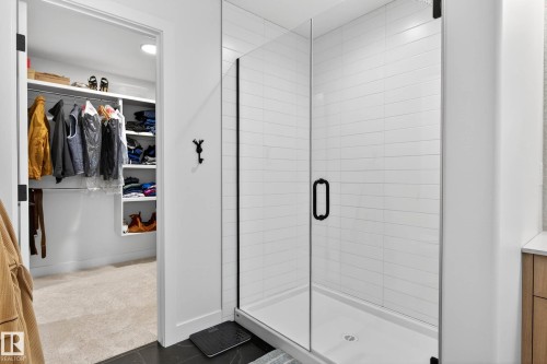 The bathroom features a spacious glass-enclosed shower with white subway tile - 345 Meadowview Drive, Fort Saskatchewan, AB - Indoor Photo Showing Other Room