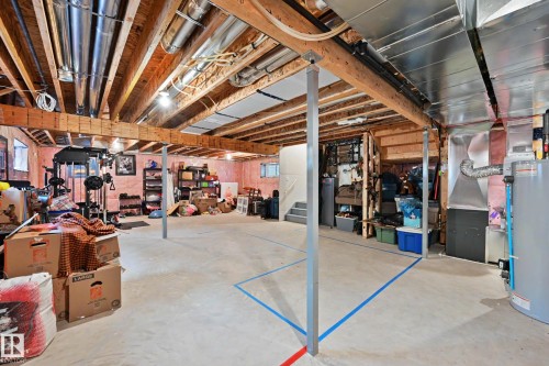 The property features an unfinished basement with exposed wooden beams and ductwork, offering significant potential for customization - 345 Meadowview Drive, Fort Saskatchewan, AB - Indoor Photo Showing Basement