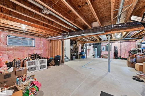 The property features an unfinished basement with exposed wooden beams, a concrete floor, and insulation visible on the walls - 345 Meadowview Drive, Fort Saskatchewan, AB - Indoor Photo Showing Basement
