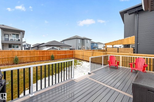 The property features a spacious deck with a durable composite surface and a white and black railing - 345 Meadowview Drive, Fort Saskatchewan, AB - Outdoor With Deck Patio Veranda With Exterior