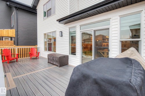 The property features a spacious deck with composite decking and a white railing, providing an outdoor living area - 345 Meadowview Drive, Fort Saskatchewan, AB - Outdoor With Deck Patio Veranda With Exterior