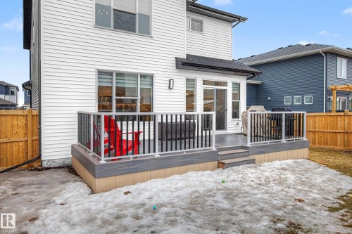The property features a white exterior with a multi-level deck, complete with stairs and railings - 345 Meadowview Drive, Fort Saskatchewan, AB - Outdoor With Deck Patio Veranda With Exterior