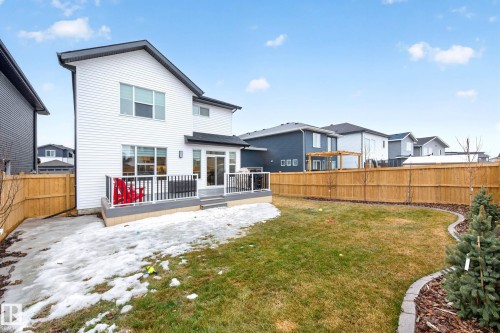 The property features a private yard with a lawn, a wooden fence, and a patio with a railing - 345 Meadowview Drive, Fort Saskatchewan, AB - Outdoor With Deck Patio Veranda With Exterior