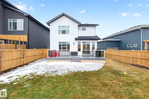 The property features a private backyard with a wooden fence and a lawn - 345 Meadowview Drive, Fort Saskatchewan, AB - Outdoor With Deck Patio Veranda