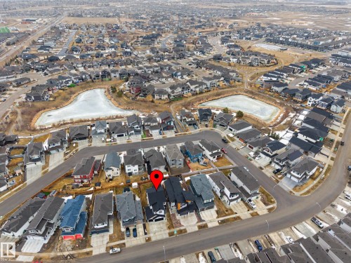 Aerial view of the property and its surrounding neighbourhood, featuring a paved road and nearby bodies of water - 345 Meadowview Drive, Fort Saskatchewan, AB - 
