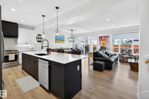 Contemporary open-concept kitchen and living area featuring light-toned flooring, white walls, and recessed lighting throughout - 345 Meadowview Drive, Fort Saskatchewan, AB - Indoor Photo Showing Kitchen With Upgraded Kitchen