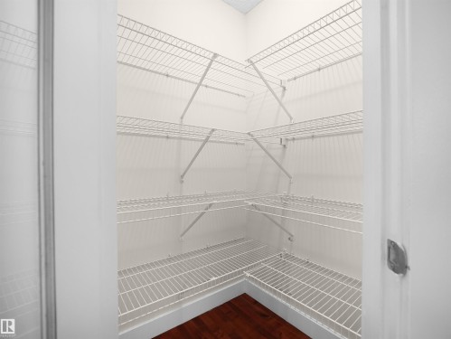 This property features a spacious closet with white wire shelving, providing ample storage - 8361 Shaske Crescent, Edmonton, AB - Indoor With Storage