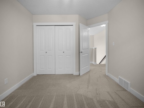 This room features neutral-toned walls, carpeting, and white trim - 8361 Shaske Crescent, Edmonton, AB - Indoor Photo Showing Other Room