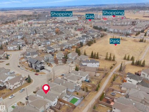 Aerial view of the property and surrounding neighborhood, featuring nearby shopping areas, a gas station, and a park - 8361 Shaske Crescent, Edmonton, AB - Outdoor With View