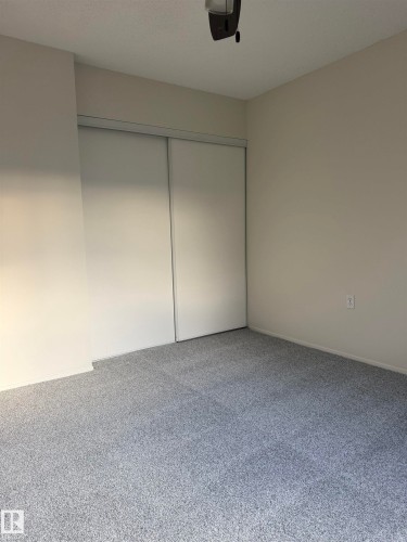 This room features light-colored walls and plush carpeting - 331 10636 120 Street, Edmonton, AB - Indoor Photo Showing Other Room