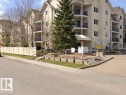 The property features a multi-story building with balconies, a pitched roof, and a light-colored exterior - 331 10636 120 Street, Edmonton, AB  - Outdoor With Balcony 