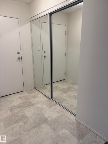 Entryway featuring light-colored walls and a door with a doorknob and deadbolt - 331 10636 120 Street, Edmonton, AB - Indoor Photo Showing Other Room