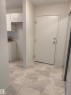 Entryway featuring light-colored flooring, white walls, and a full-length mirrored closet door - 331 10636 120 Street, Edmonton, AB  - Indoor Photo Showing Other Room 
