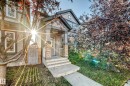 The property features light-colored siding, a covered front porch with stone accents, and a concrete walkway leading to the entrance - 3116 Arthurs Crescent, Edmonton, AB 