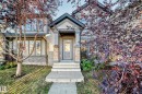 The property features an inviting entrance with a covered porch and stone accents - 3116 Arthurs Crescent, Edmonton, AB 