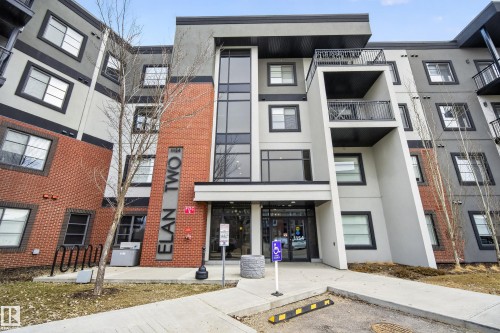 The property features a multi-story exterior with a combination of brick and panel siding - 127 1154 Adamson Drive, Edmonton, AB - Outdoor With Balcony With Facade
