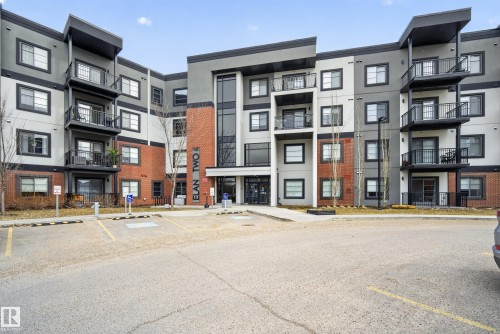 The property features a contemporary multi-story facade with a combination of brick and painted exterior finishes - 127 1154 Adamson Drive, Edmonton, AB - Outdoor With Balcony With Facade