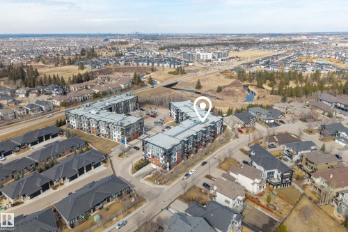 Aerial view showcasing the property within a residential setting, featuring various residential structures and roadways - 127 1154 Adamson Drive, Edmonton, AB - Outdoor With View