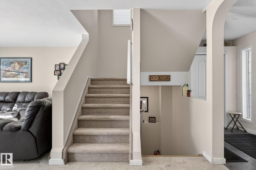 The property features a staircase with carpeted treads and risers, leading to an upper level - 19 Escada Close, St. Albert, AB - Indoor Photo Showing Other Room